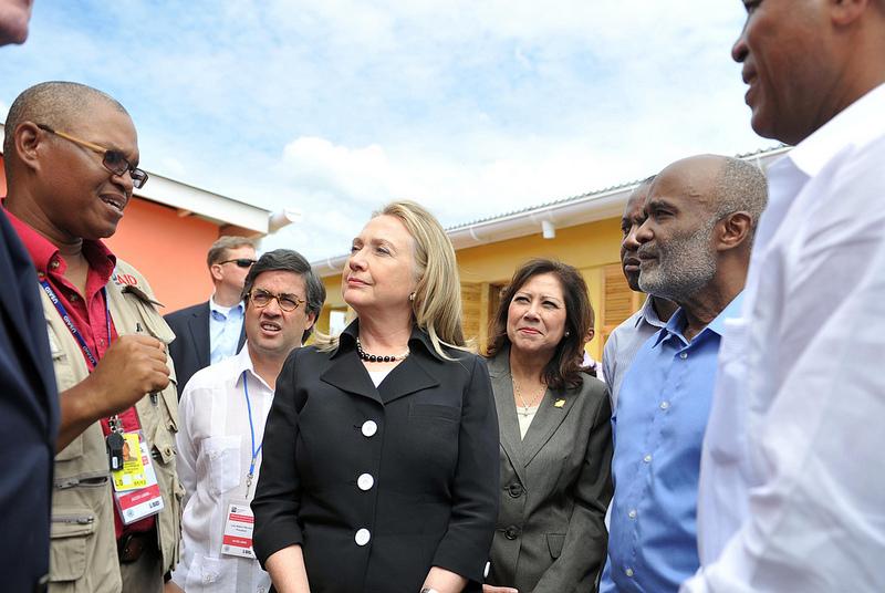 Secretary Clinton Is Briefed By USAID/Haiti Engineer Nicoleau